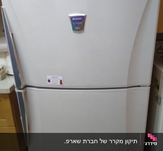 מקרר לבן עם לוגו שארפ ותווית שירות